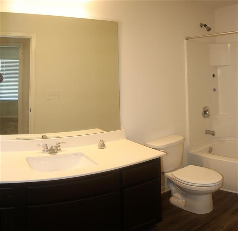 1625 Honeysuckle Path Conyers, GA 30012 - Photo 16 of 17 a bathroom with a sink a toilet and shower