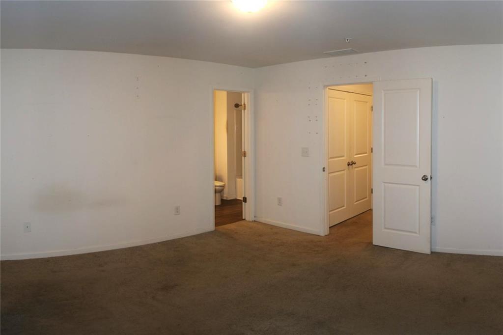1625 Honeysuckle Path Conyers, GA 30012 - Photo 10 of 17 an empty room with windows