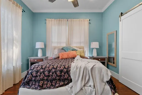 a bedroom with a bed and wooden floor