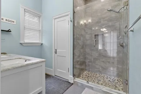 a bathroom with a shower and sink