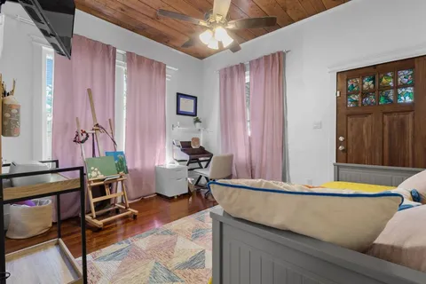 a bedroom with a bed and flat screen tv