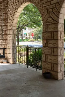 a view of a porch with chairs and couches next to a yard