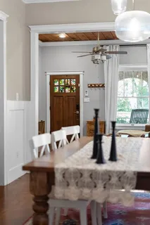 a dining table with chairs and window