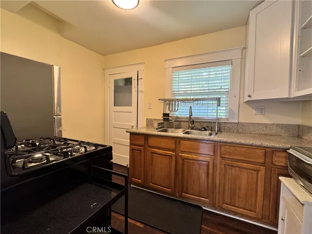 a kitchen with sink stove and window