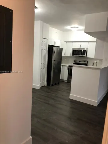 a kitchen with stainless steel appliances granite countertop a refrigerator and a stove