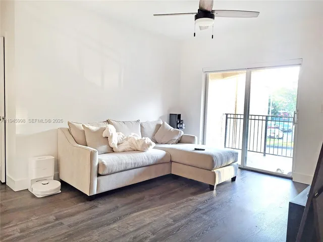 a living room with furniture and a large window