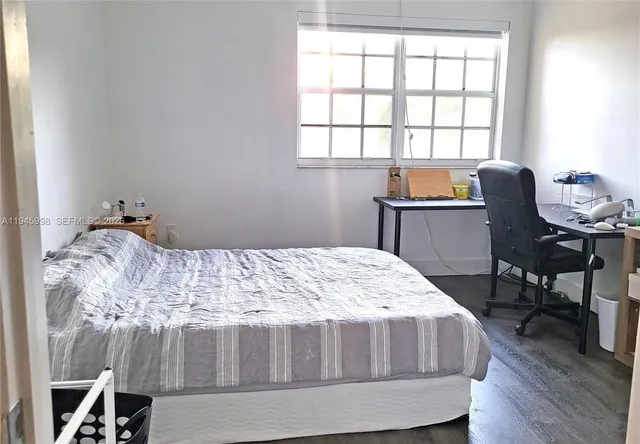 a bed sitting in a bedroom next to a window