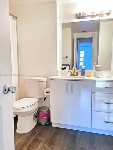 a bathroom with a sink toilet and mirror