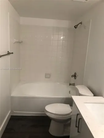 a bathroom with a sink a toilet and bathtub