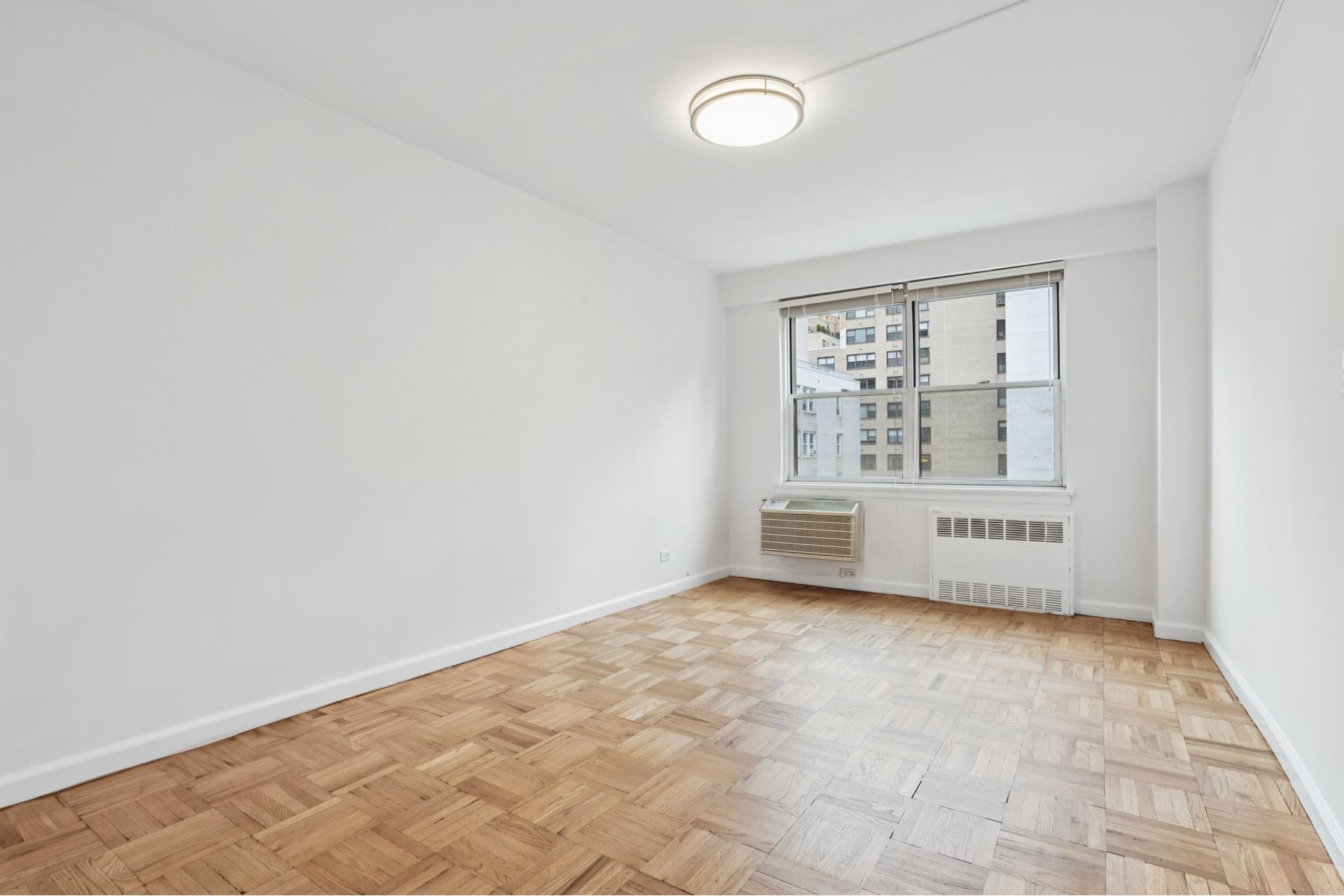 300 East 71st Street, Unit 9G Manhattan, NY 10021 - Photo 15 of 17 an empty room with windows