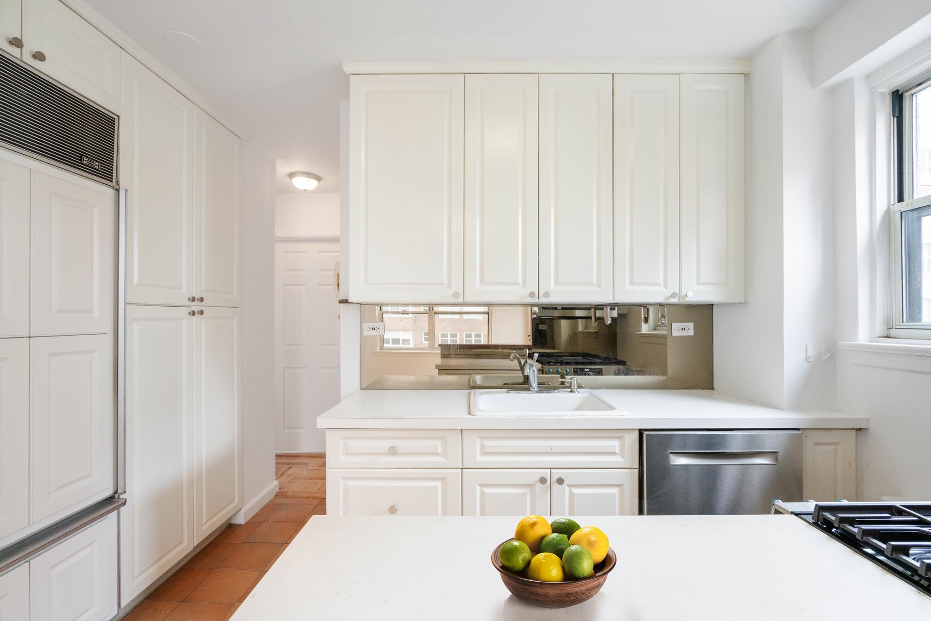 300 East 71st Street, Unit 9G Manhattan, NY 10021 - Photo 6 of 17 a kitchen with a white cabinets and window
