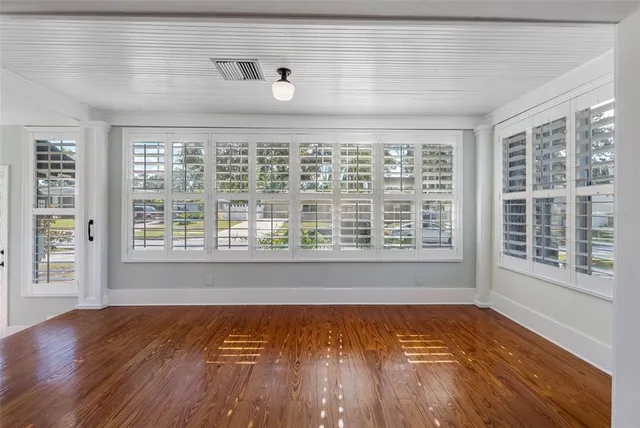 a kitchen with wooden floors and white walls