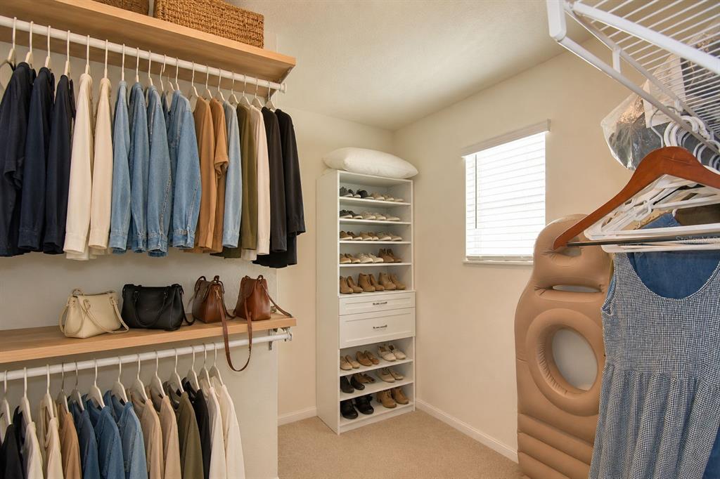 2839 Moulin Road Davenport, FL 33837 - Photo 41 of 75 a view of walk in closet with clothes and shoes