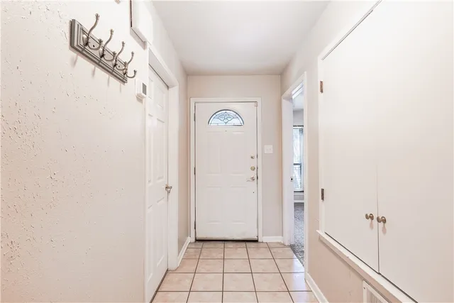 a view of a hallway view with wooden floor and a bathroom