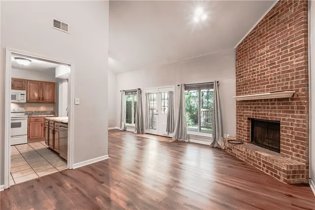 a view of a room with wooden floor and white walls