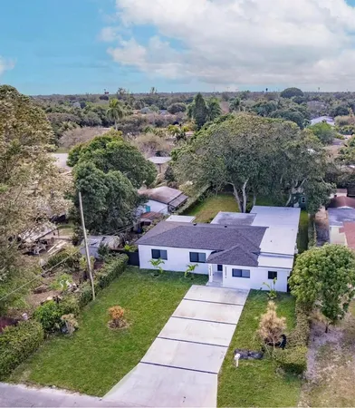 an aerial view of a house with a garden