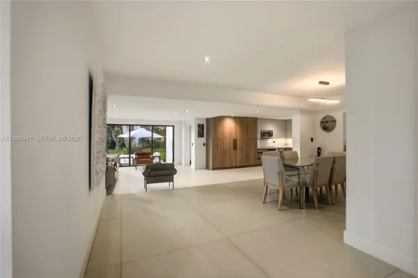 a living room with furniture and a large window with balcony view