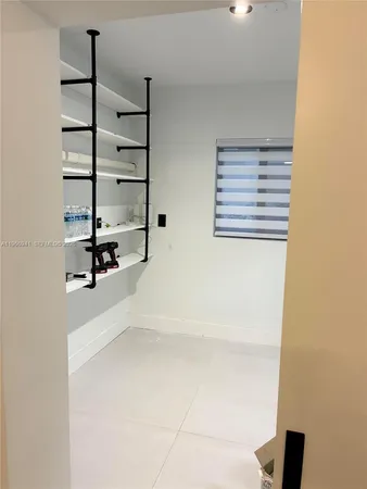 a bedroom with a bed and chandelier