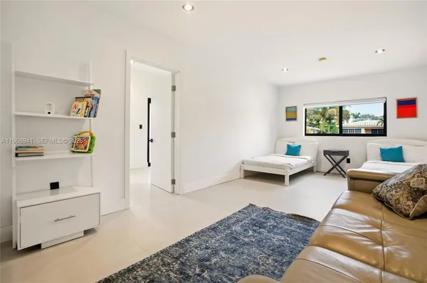 a bathroom with a granite countertop sink a toilet a mirror and shower