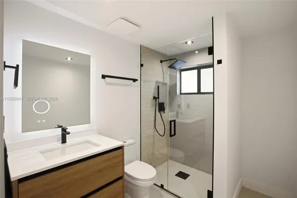 a bathroom with a sink toilet and shower