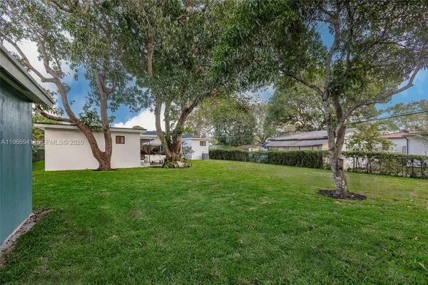 a view of a backyard with large trees