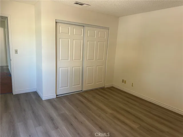 a view of walk in closet with wooden floor