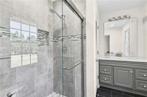 a bathroom with a shower and a sink