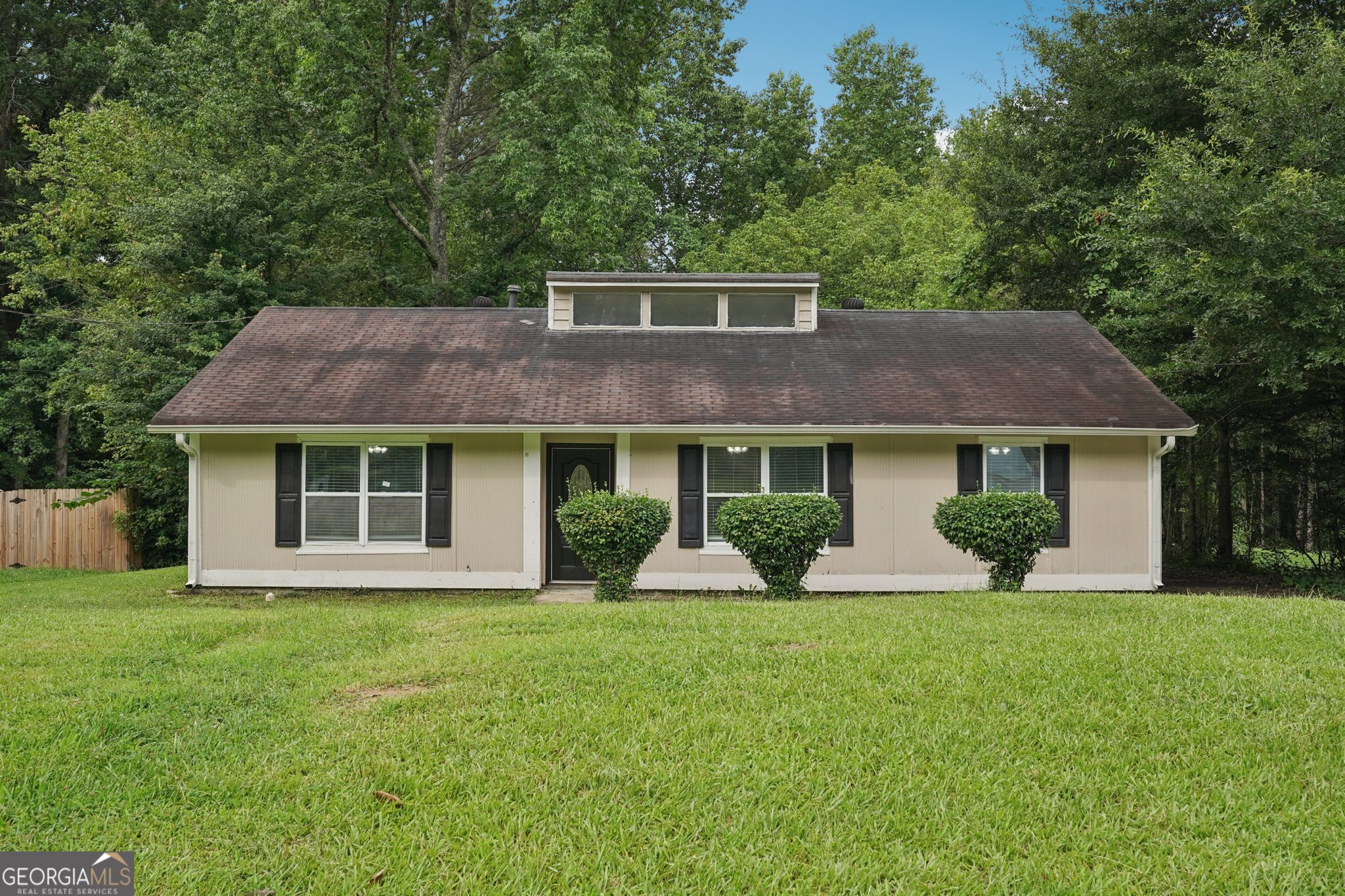 a front view of house with yard and green space