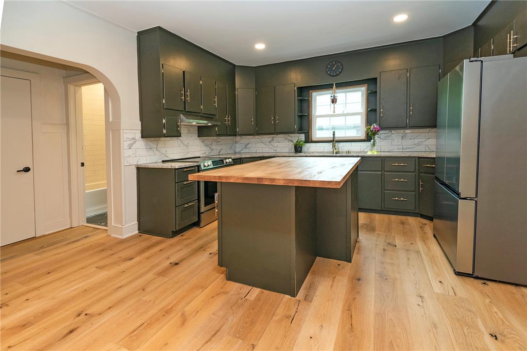 100 Creek Road Bangor, PA 18013 - Photo 29 of 51 A well-appointed kitchen features a central island, rich cabinetry, and durable wood flooring.
