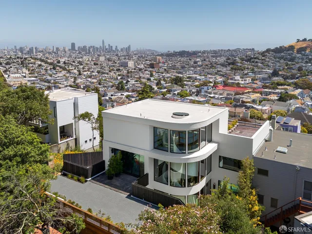 a front view of a building with trees