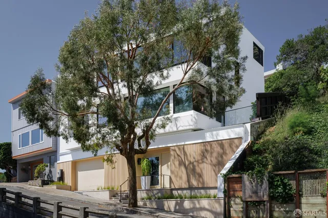 a view of a house with a tree