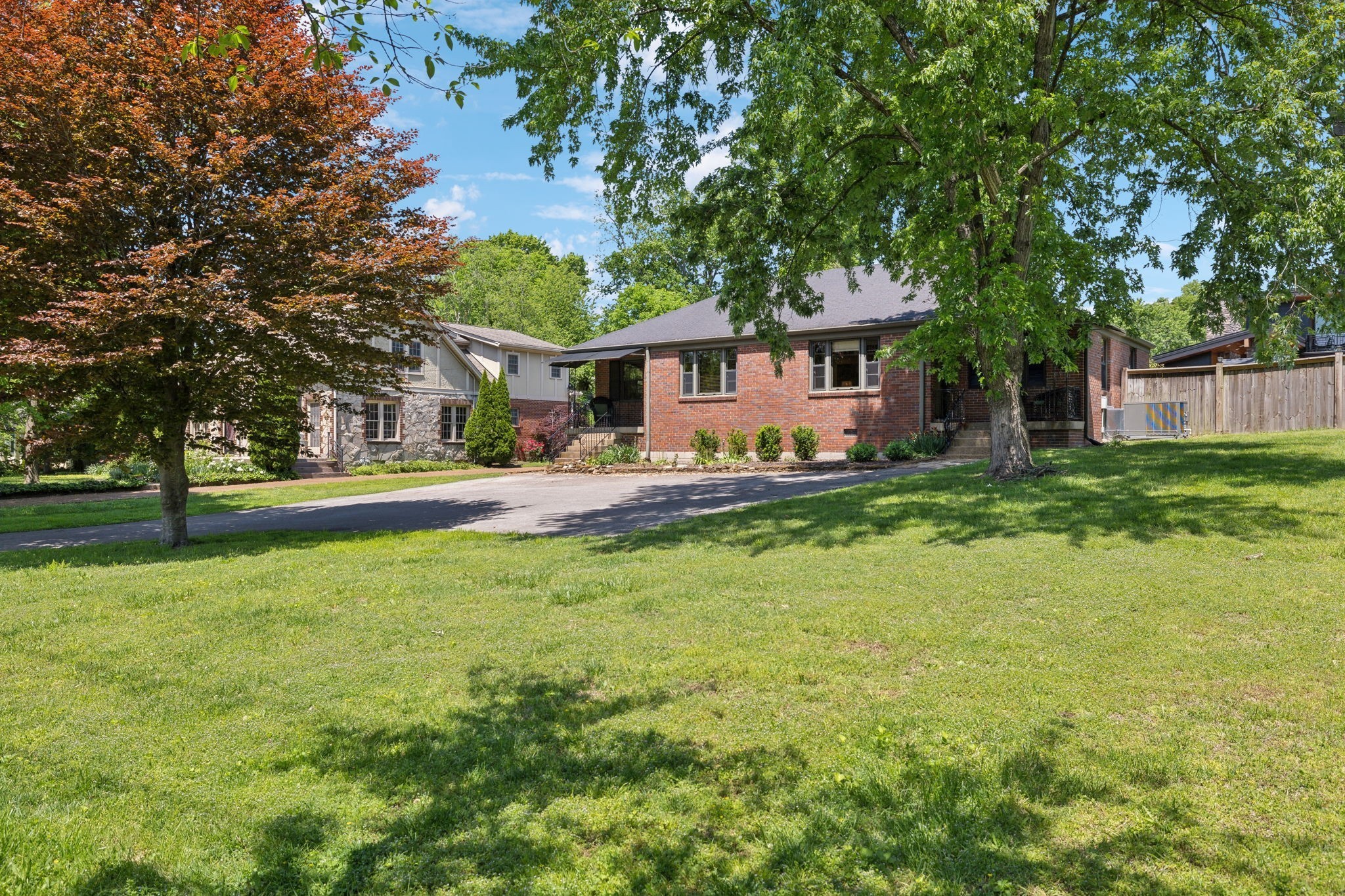 a front view of house with yard and trees