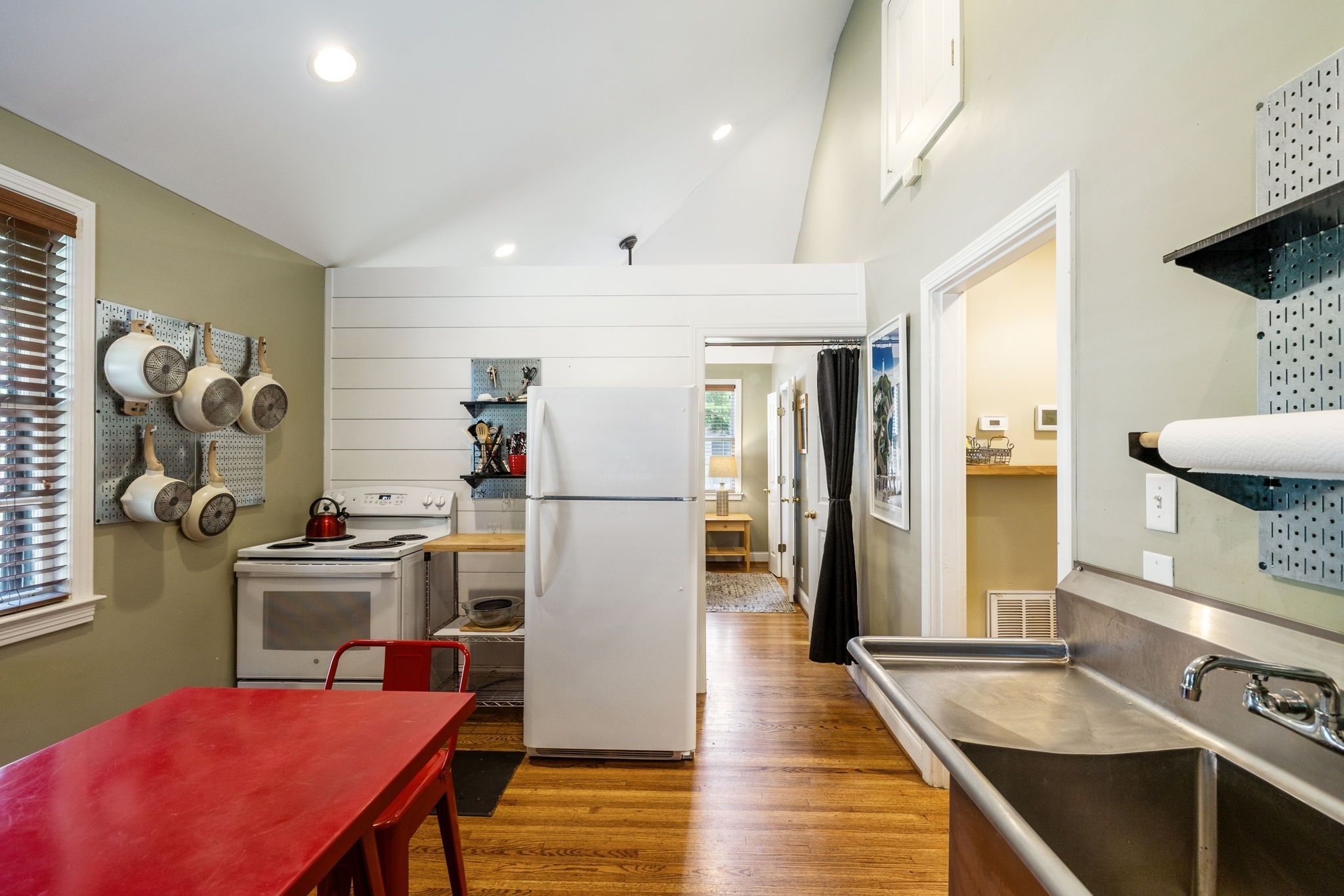 4202 Murphy Road Nashville, TN 37209 - Photo 23 of 34 a kitchen with kitchen island a stove and a refrigerator