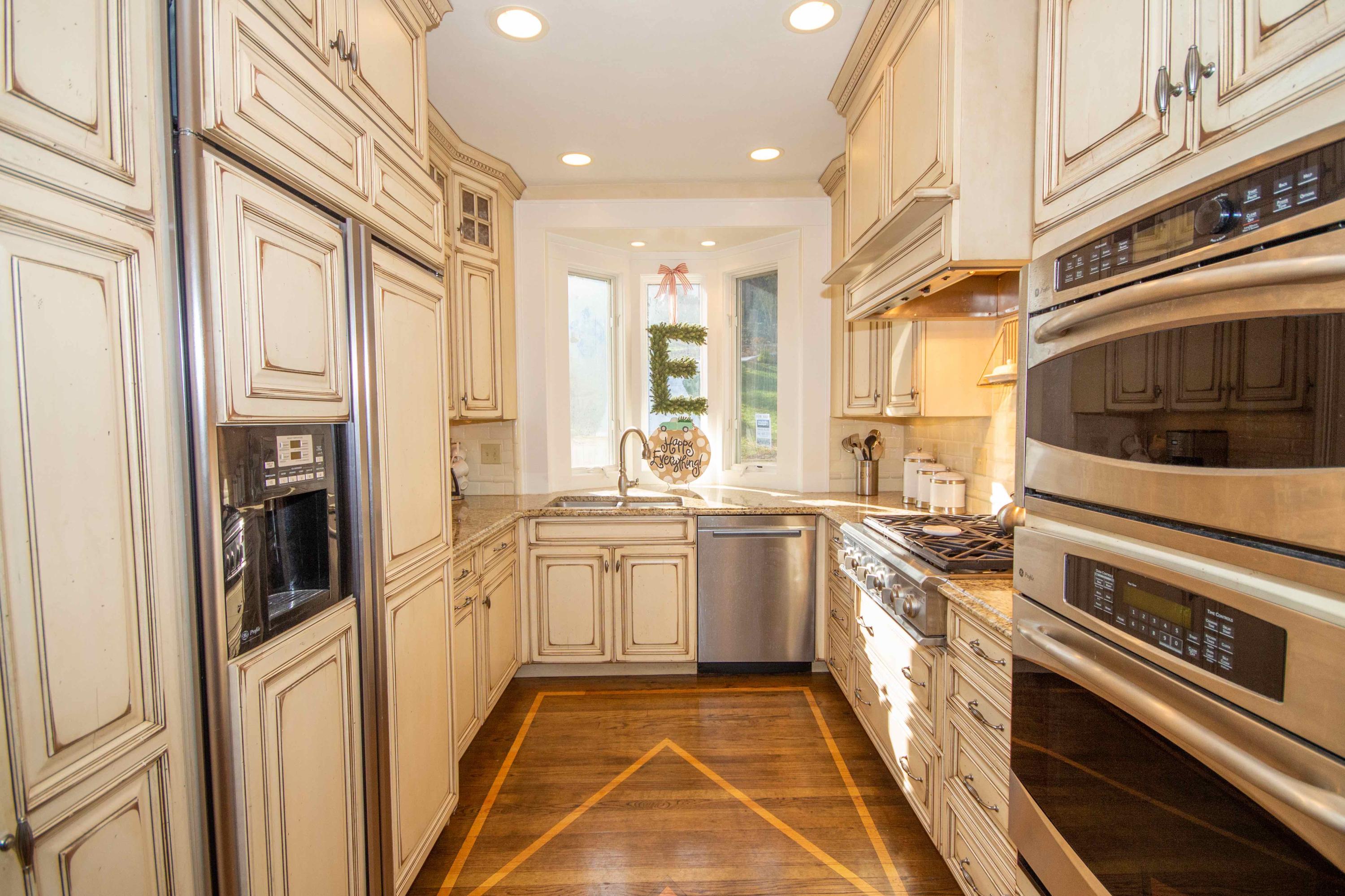 2743 Richelieu Avenue Southwest Roanoke, VA 24014 - Photo 28 of 54 a kitchen with stainless steel appliances granite countertop a stove a sink and a refrigerator