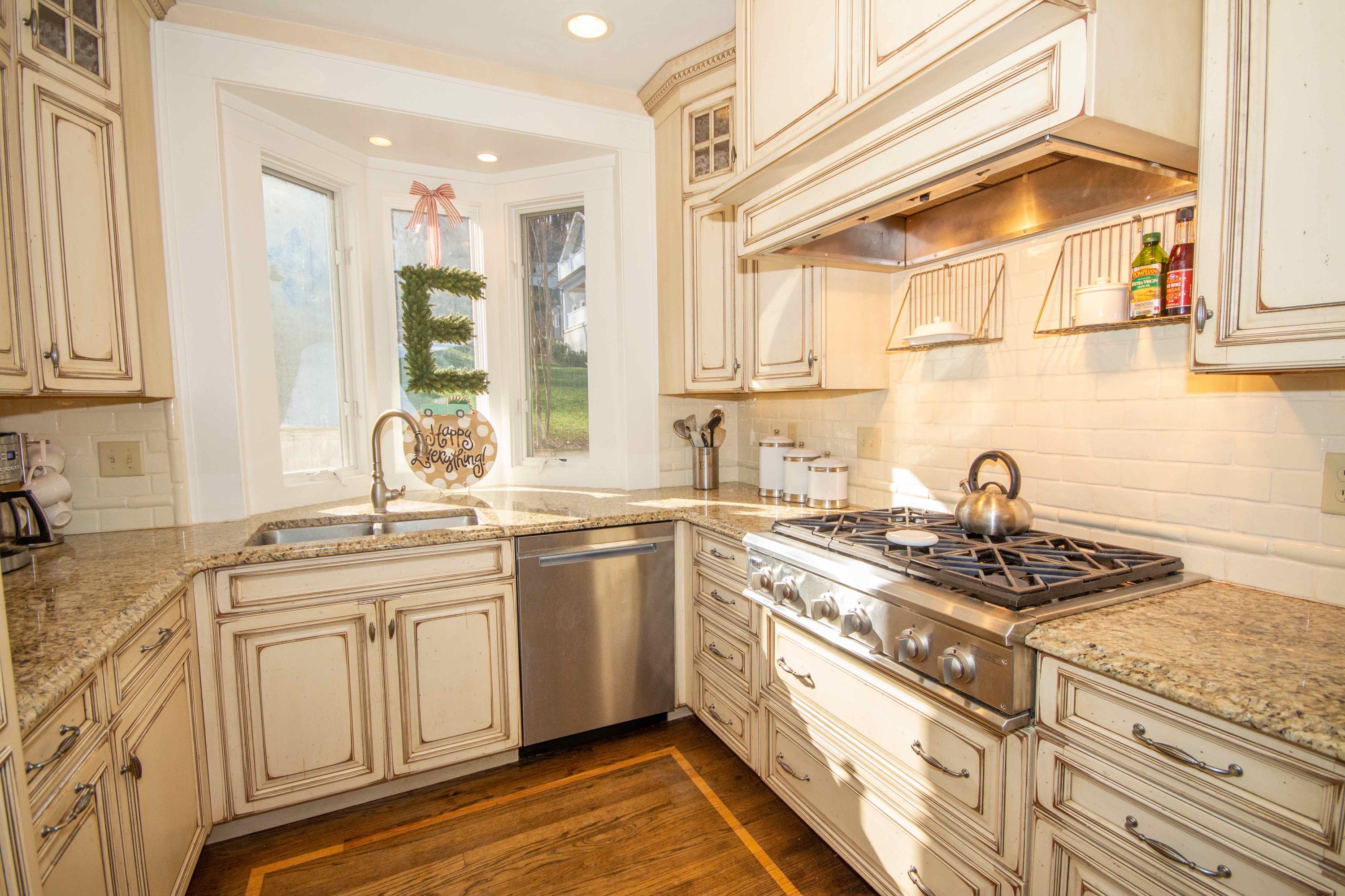2743 Richelieu Avenue Southwest Roanoke, VA 24014 - Photo 29 of 54 a kitchen with stainless steel appliances granite countertop a sink stove and cabinets