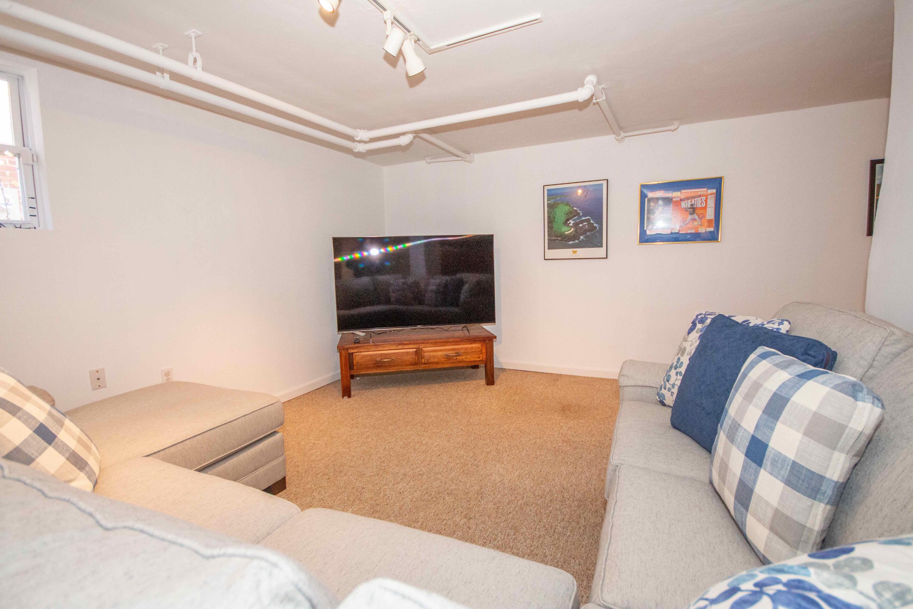 2743 Richelieu Avenue Southwest Roanoke, VA 24014 - Photo 48 of 54 a living room with furniture and a flat screen tv