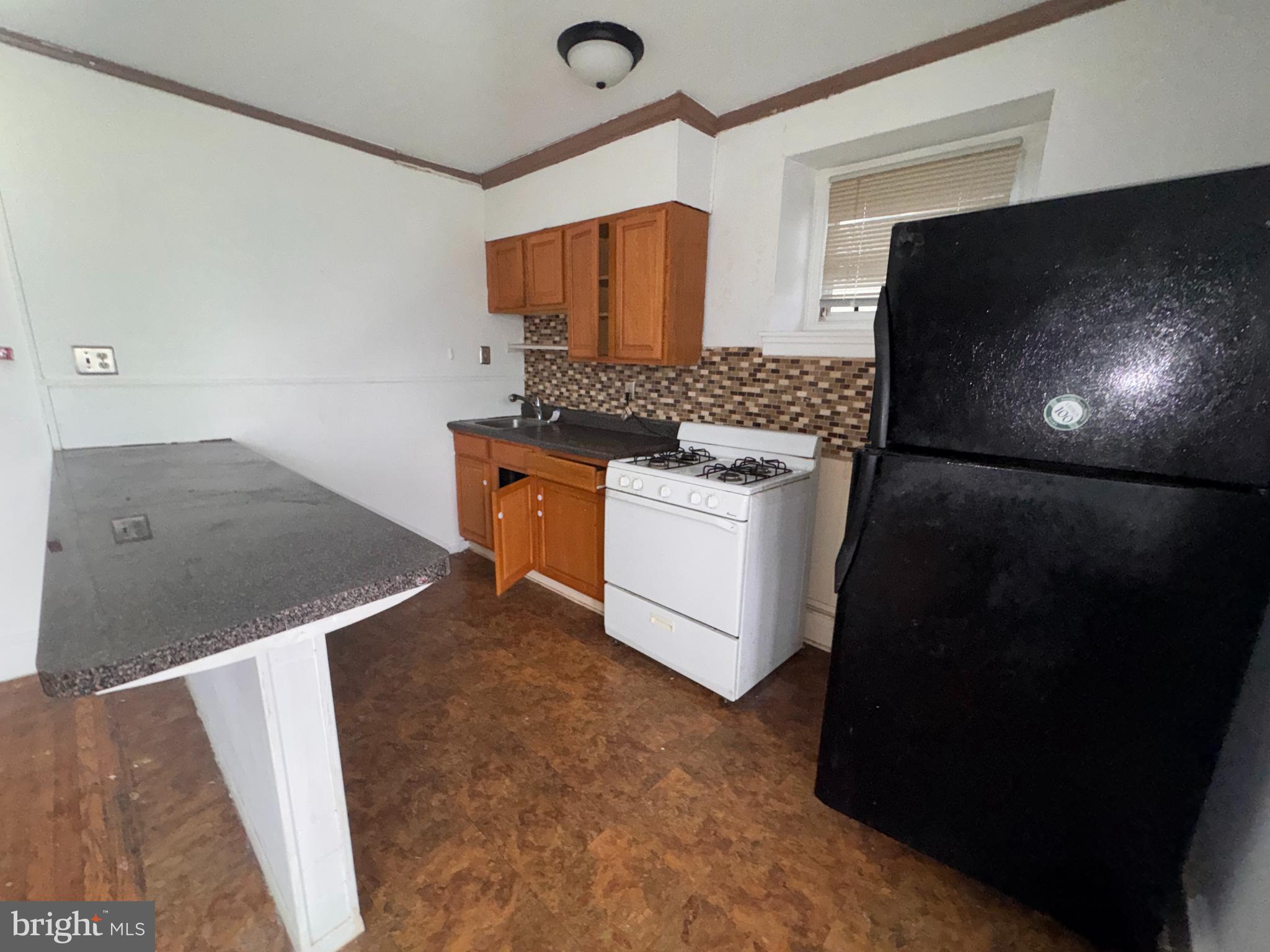 813 North 64th Street Philadelphia, PA 19151 - Photo 15 of 23 a kitchen with stainless steel appliances granite countertop a stove a microwave and a refrigerator