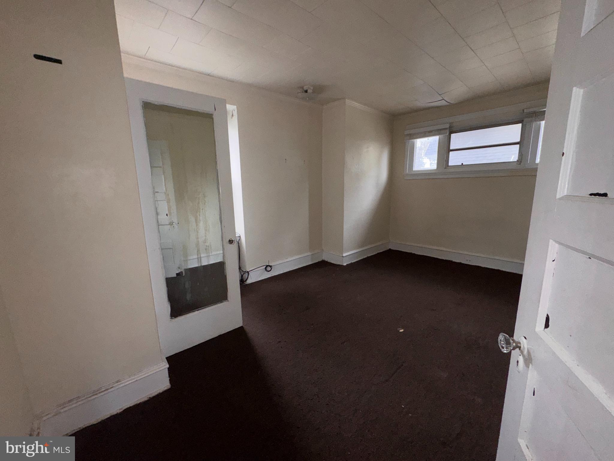 813 North 64th Street Philadelphia, PA 19151 - Photo 18 of 23 wooden floor in an empty room with a window