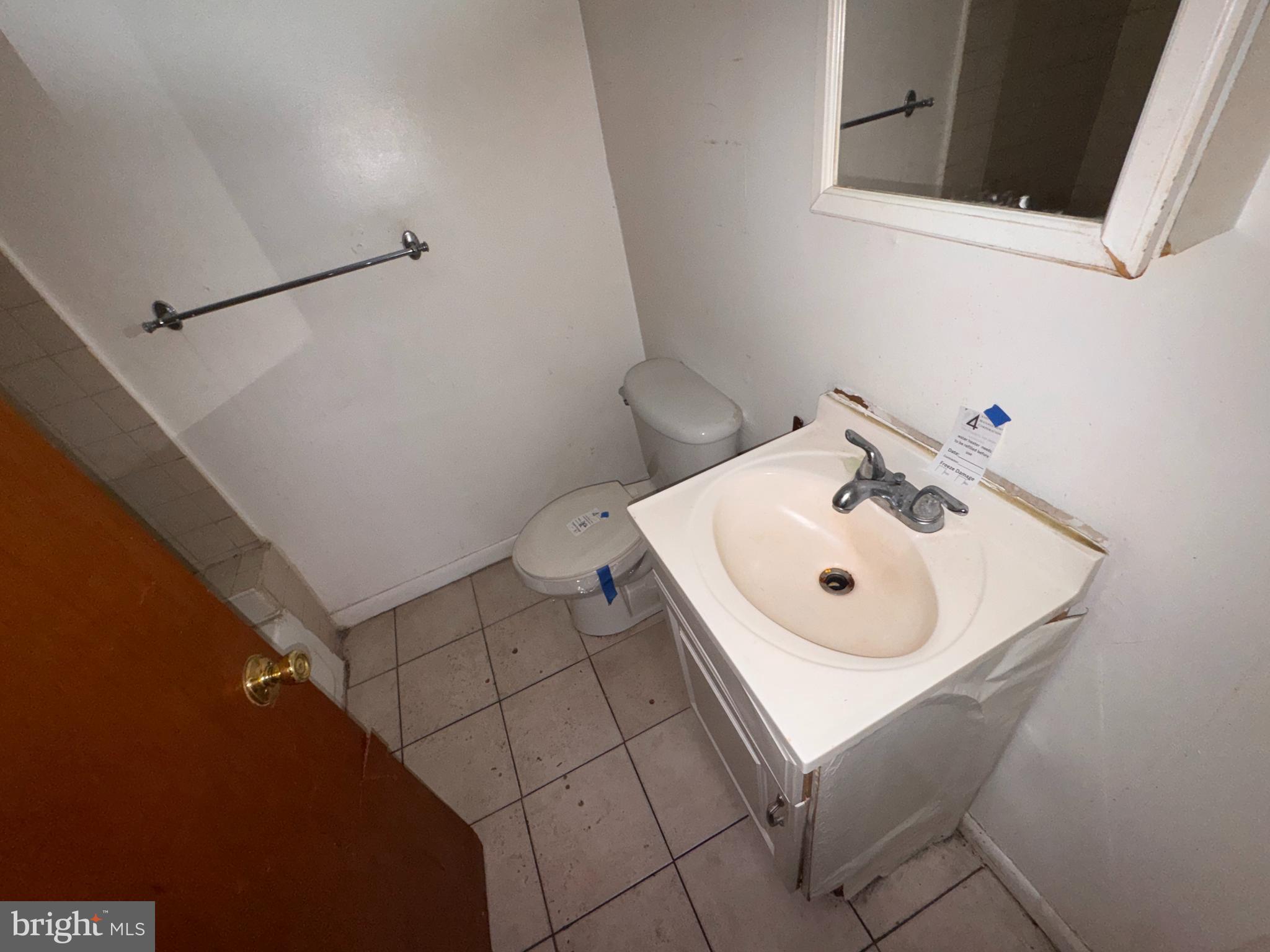 813 North 64th Street Philadelphia, PA 19151 - Photo 10 of 23 a bathroom with a sink toilet and a mirror