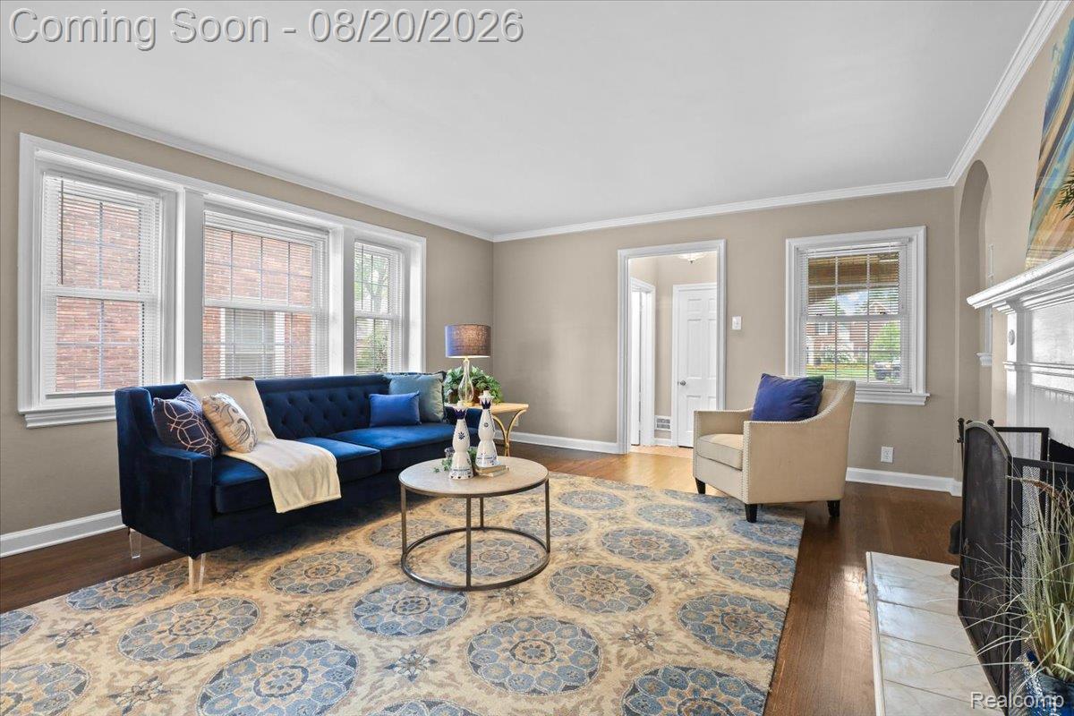 429 Moran Road Grosse Pointe, MI 48236 - Photo 5 of 36 Elegant living room featuring hardwood flooring, crown molding, and large multi-pane windows flooding the space with natural light
