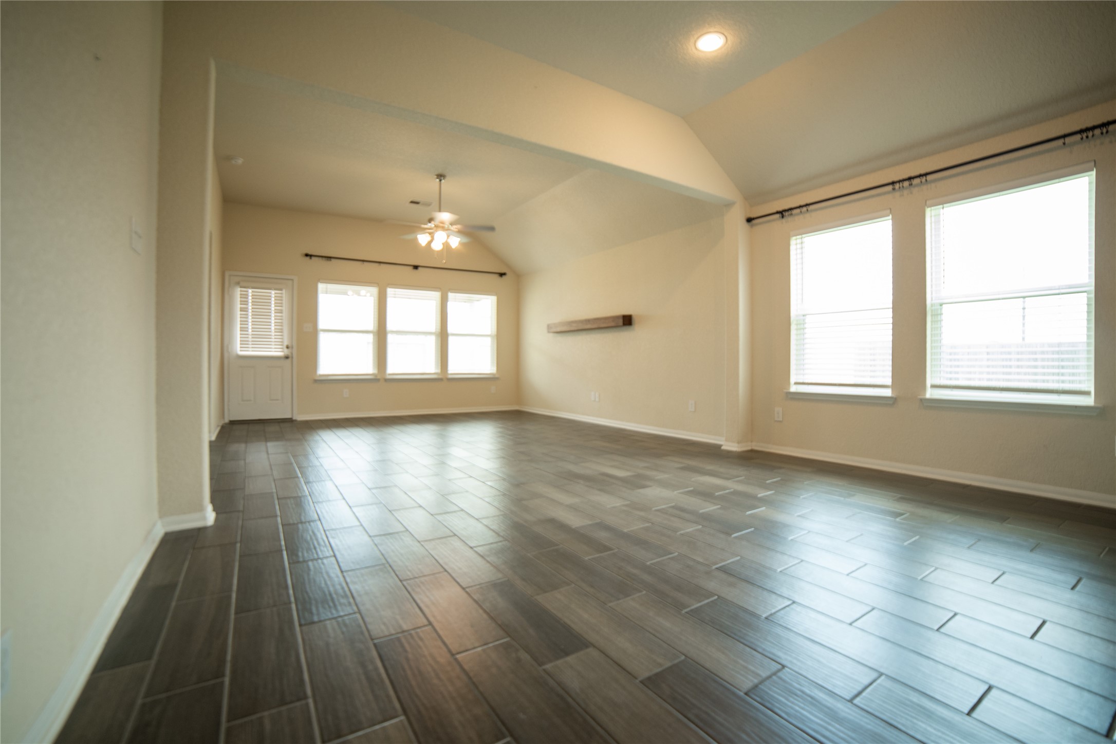 3006 Tandem Court Rosenberg, TX 77471 - Photo 11 of 33 an empty room with wooden floor and windows