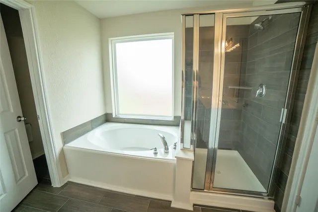 a bathroom with a tub and shower