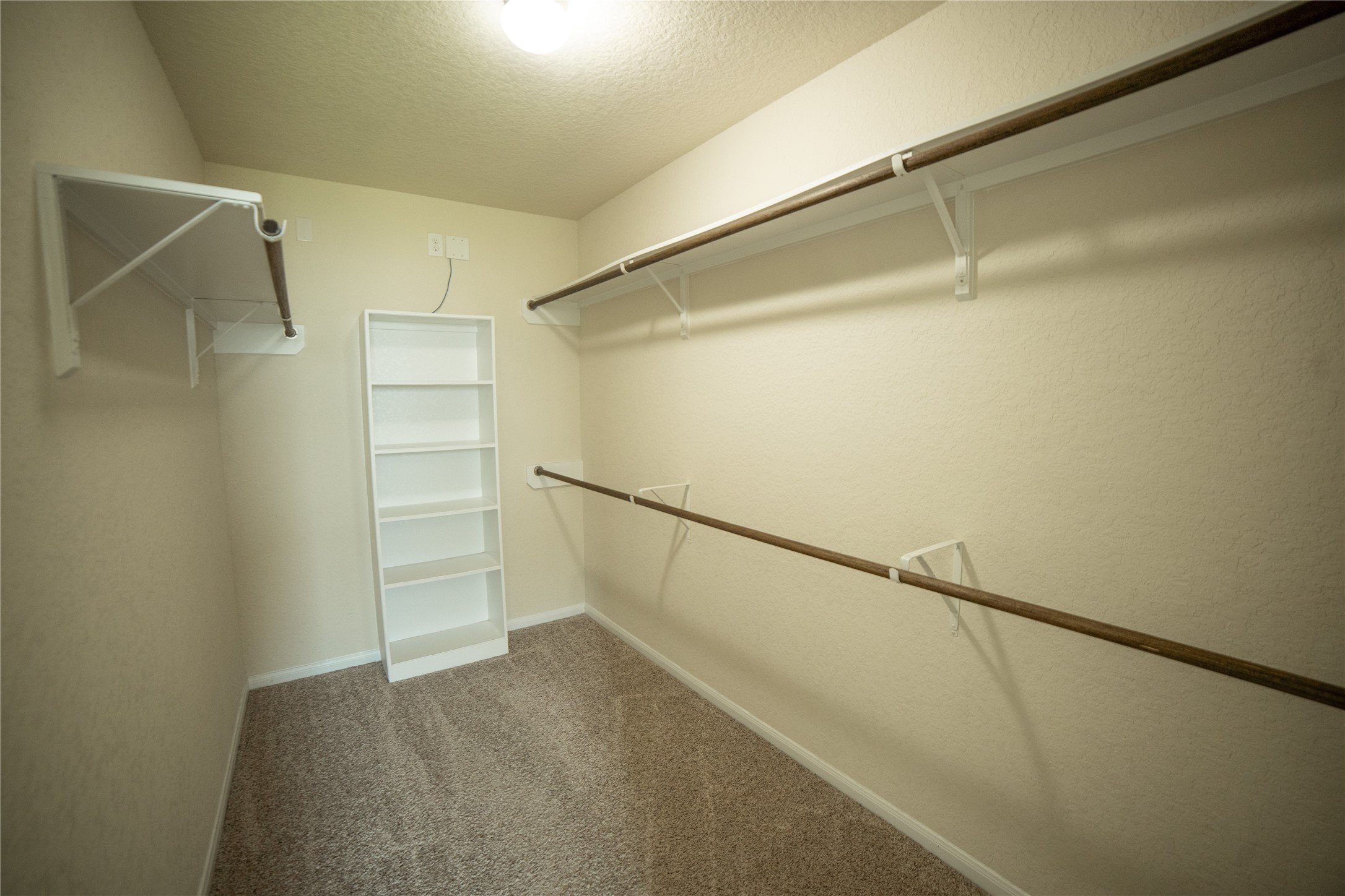 3006 Tandem Court Rosenberg, TX 77471 - Photo 18 of 33 a view of walk in closet with empty racks
