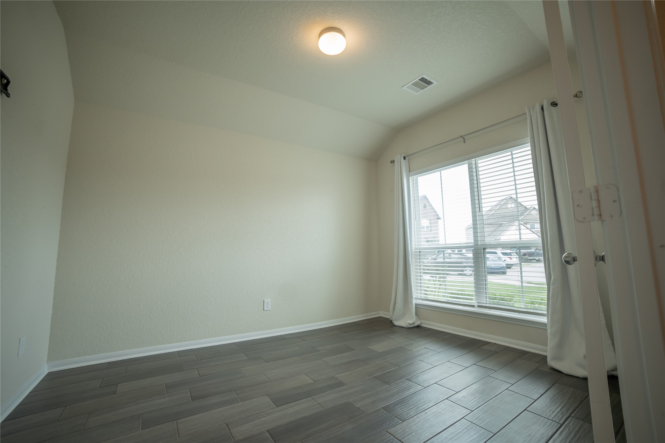 3006 Tandem Court Rosenberg, TX 77471 - Photo 5 of 33 an empty room with wooden floor and windows