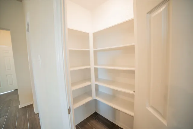 a view of walk in closet with empty racks