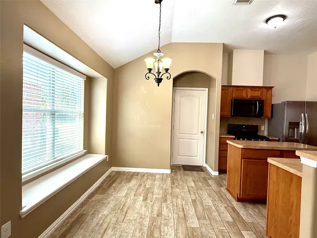 a view of a kitchen with a stove cabinets and a wooden floor