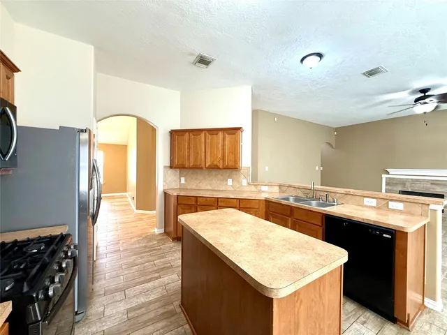 a kitchen with a sink a stove and cabinets