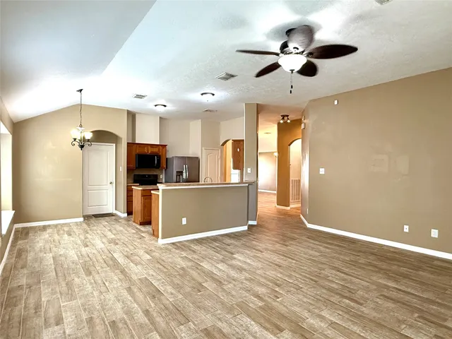 a view of kitchen with refrigerator microwave and wooden floor
