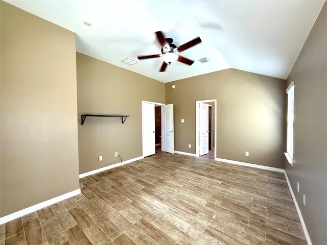 a view of a livingroom with a ceiling fan window and entryway