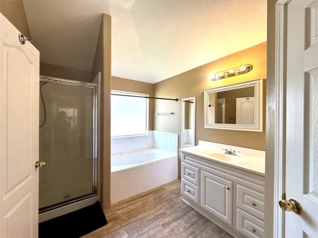 a spacious bathroom with a tub and a sink